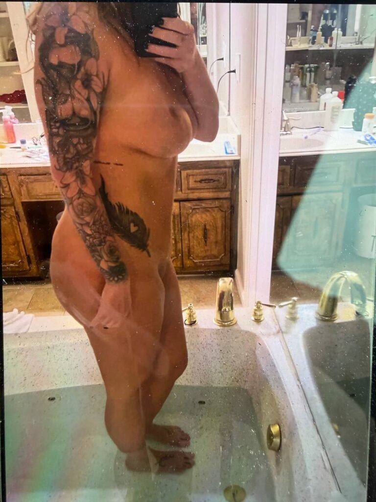 tatooed milf taking a nude pic in the bathroom