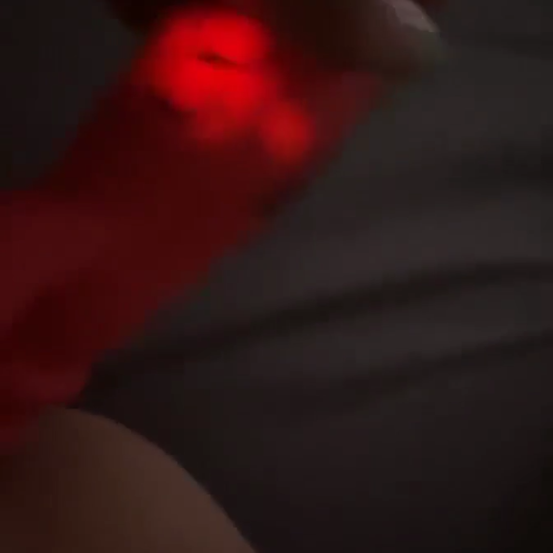 horny woman using a light up dildo on her pussy