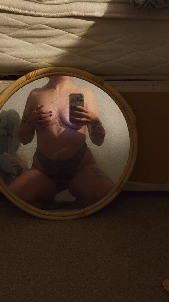 woman taking a nude pic with a mirror